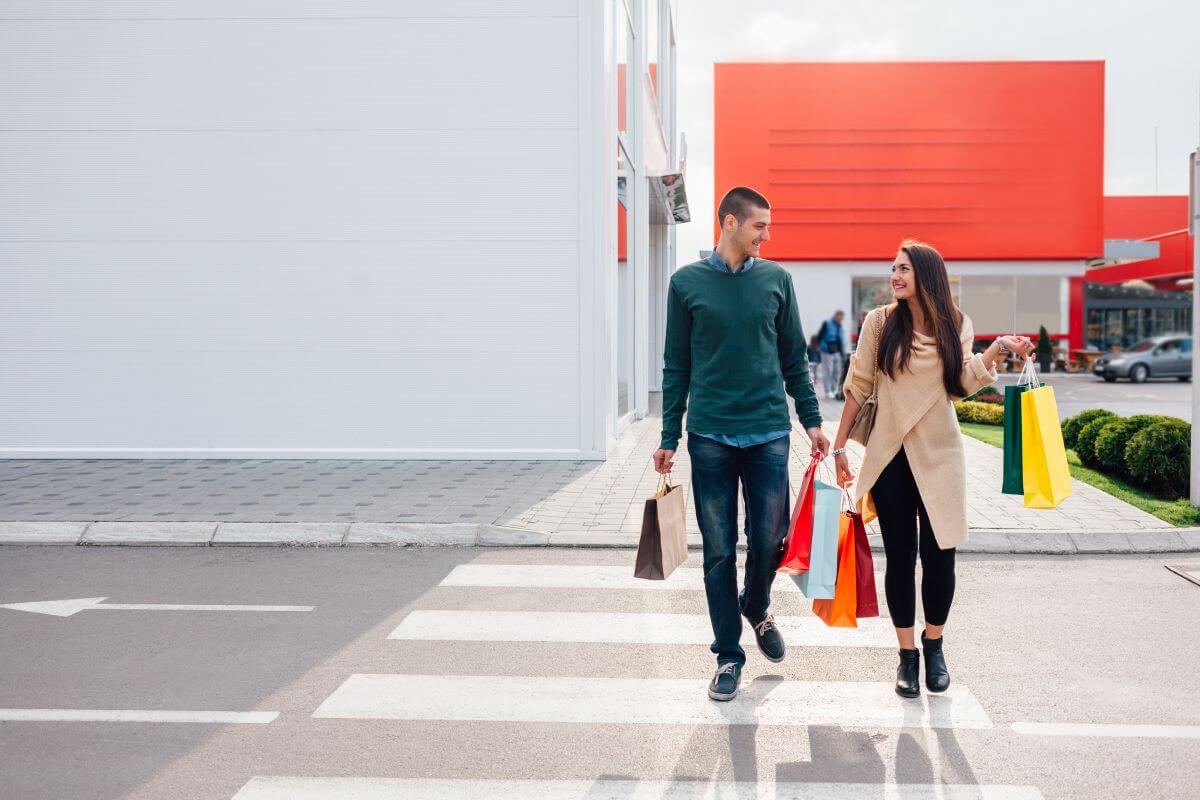 A man and a woman walks along a paved path.